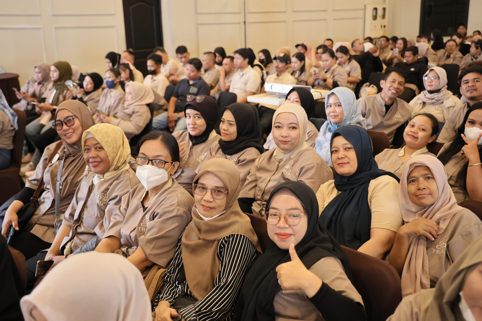 Terapis Truly Home Massage tersenyum dan mengacungkan jempol di sela sesi diskusi gathering Jabodetabek